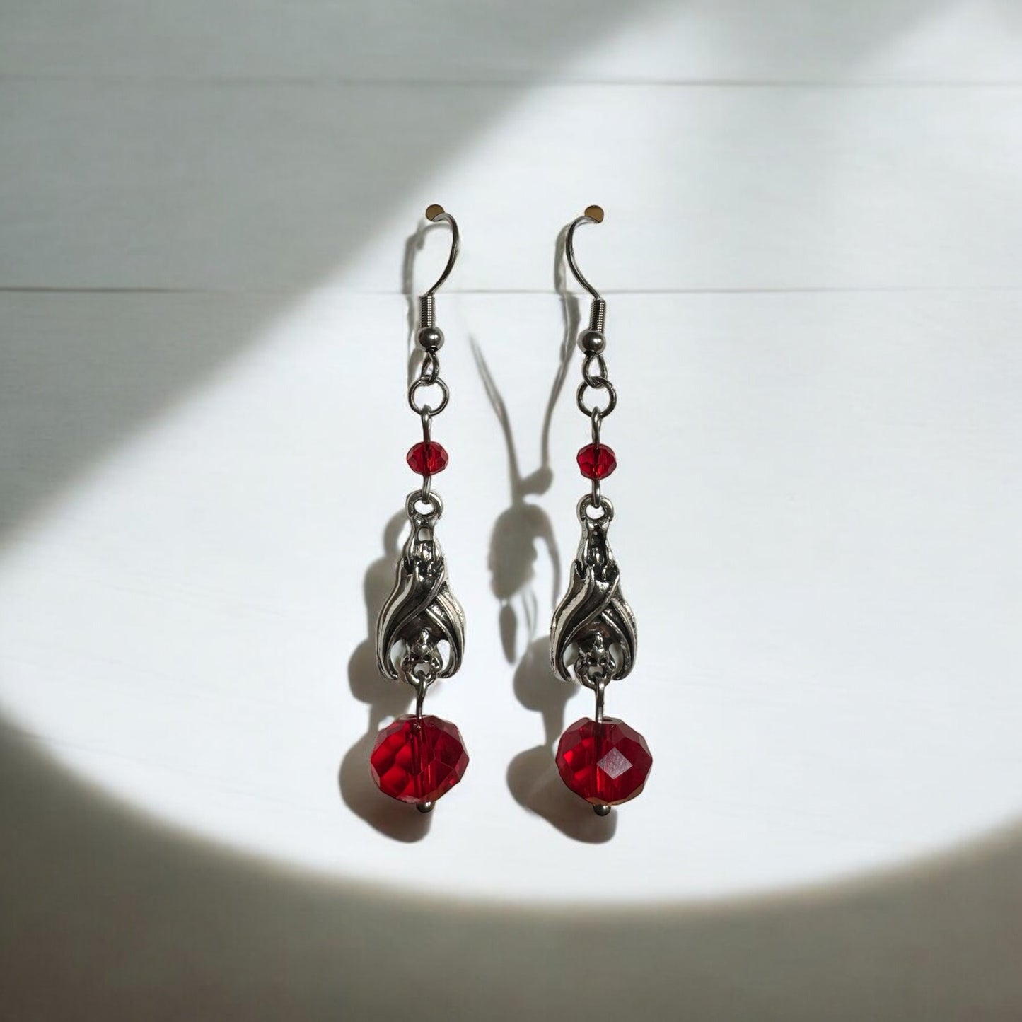 Silver Sleeping Bat and Red Glass Bead Dangle Earrings